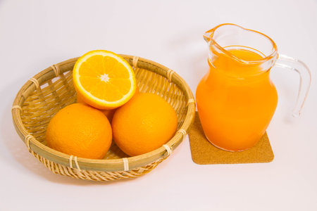 Orange juice and orange on white backgroundの写真素材