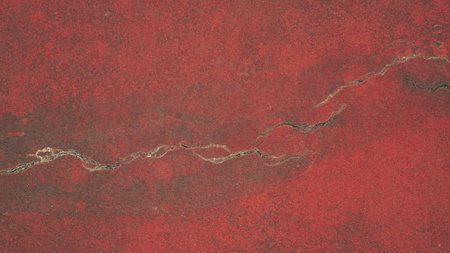 Cracks on red cement floor.の写真素材