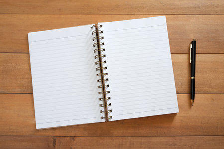 blank open notebook with pen on deskの写真素材
