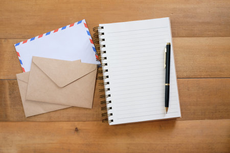 blank notepad with envelope on tableの写真素材