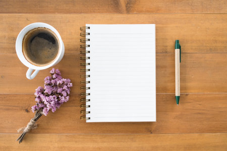 blank notepad with a cup of coffee on deskの写真素材