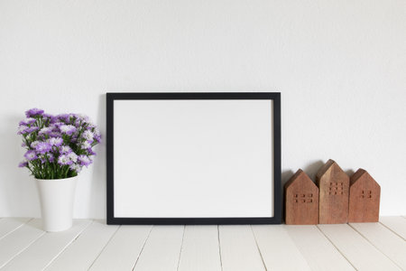blank frame photo on wooden table at home