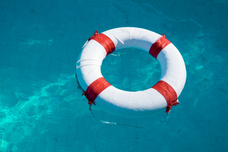 lifebuoy floating on water at the swimming poolの写真素材