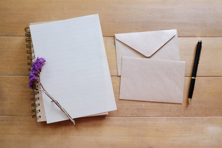 blank paper with brown envelope on wooden desk.view from above.の写真素材