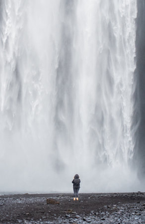 Majestic SkÃ³gafoss Waterfall with Person for Scale