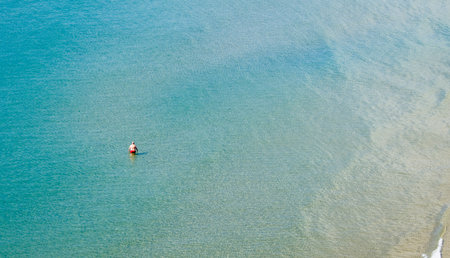 alone man swimming in the seaの写真素材