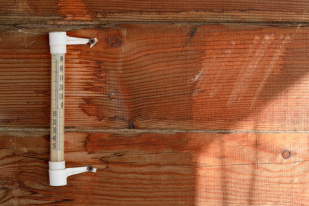A wooden wall of pine horizontal boards, a rough surface, an old mercury thermometer, warm sunlight....