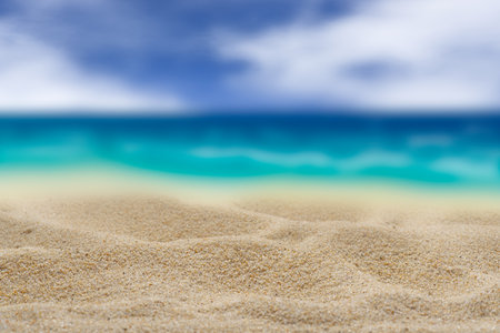 Background. Yellow sand on a blurred turquoise sea background. Cloudy sky Free space for any material.の写真素材
