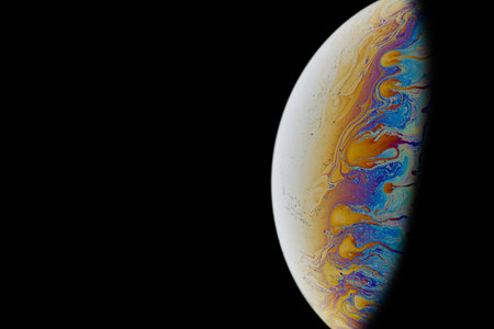 Half a soap bubble. Colorful patterns. Close-up. Partial defocus. Fictional planet. Science fiction. A high resolution. Free space for text or image.の写真素材