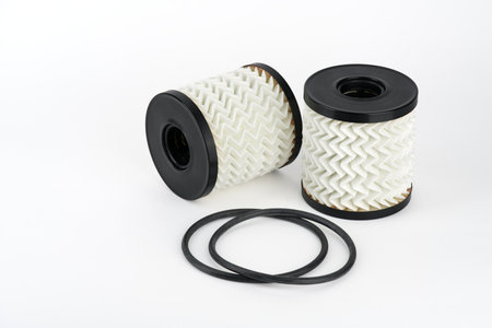 Isolate. Two oil filter cartridges and gaskets on a white background. Close-up. A high resolution. Maintenance of transport engines.の写真素材