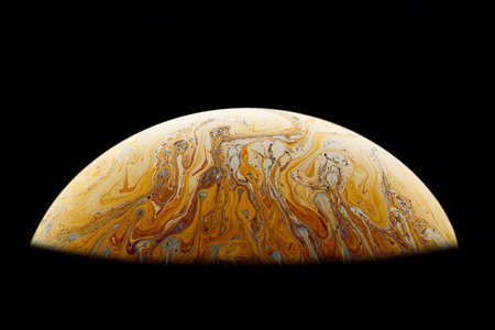 A black background with half of a soap bubble. Bright, colorful patterns.の写真素材