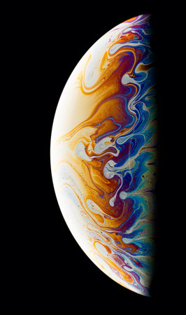 A black background with half of a soap bubble. Bright, colorful fantastic patterns.の写真素材