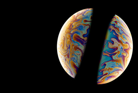 Two of colorful soap bubbles in the shape of ball on a black background. High resolution.の写真素材