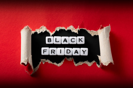 Close-up of "Black Friday" acrylic bead sign inside torn red paper. High-resolution photo.の写真素材