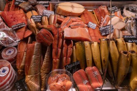 RUSSIA, Ufa - March 27, 2026: Tsentralnyy Trading Complex. Assorted fish from Russian producers including smoked salmon, mackerel, trout, and red caviar in a display caseのeditorial素材