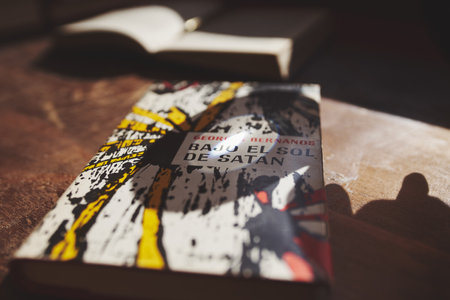 Brihuega, Spain 11-13-2020 Sunbeam concentrated on the cover of a book through a magnifying glassのeditorial素材