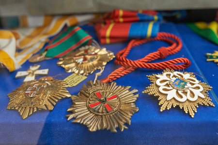Brihuega, Spain 11-13-2020 Different golden military medals on blue cloth in an antique shopのeditorial素材