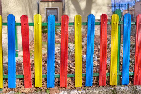 Colorful wooden fence painted in blue, yellow and red.の写真素材