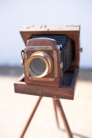 Brihuega, Spain 01-12-2020 Vintage bellows camera with wooden tripod and gold detailsのeditorial素材