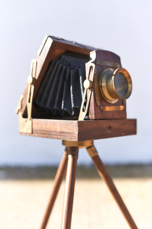 Brihuega, Spain 01-12-2020 Vintage bellows camera with wooden tripod and gold detailsのeditorial素材