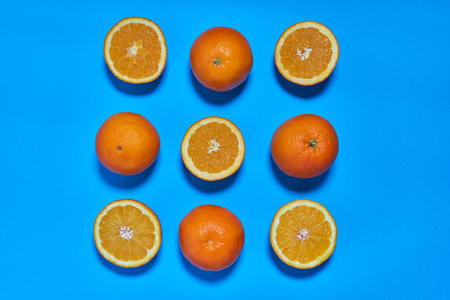 Whole and split oranges on a blue background. CITRUS CITRICの写真素材