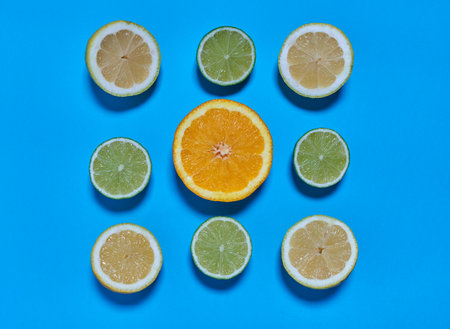 Orange, lime and lemon slices on a blue background. CITRUS CITRICの写真素材