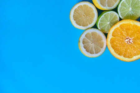 Orange, lime and lemon slices on a blue background. CITRUS CITRIC