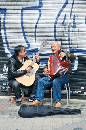 11-18-2012 Madrid, Spain - Talented duo performs lively tunes with accordion and guitar on a vibrant city streetのeditorial素材