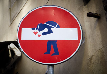 06-11-2013 Florence, Italy - A whimsical "No Entry" sign in Florence, adorned with a charming police officer illustrationのeditorial素材