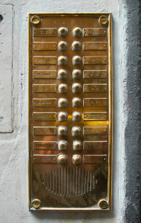 06-11-2013 Florence, Italy - A detailed shot capturing the vintage elegance of a golden antique entrytelephone / Intercomのeditorial素材
