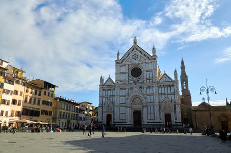 07-11-2013 Florence, Italy - Vibrant piazza life surrounding the iconic facade of Santa Croce Church in Florenceのeditorial素材