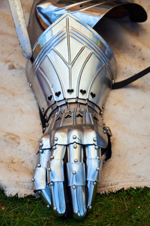 A steel medieval armor gauntlet displayed on the ground, showcasing historic craftsmanship and battle heritageの写真素材