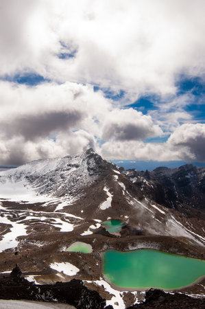 view of mountains, lakes and blue sky with white clouds in tongarino national park new zealandの写真素材
