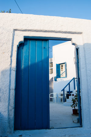 blue door in a typical white house in santoriniの写真素材