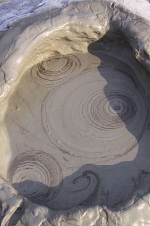 Mud circles in mud volcano in Romania. The Berca Mud Volcanoes is a geological and botanical reservation. Small volcano-shaped structures caused by the eruption of mud and natural gases.の写真素材