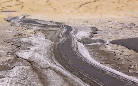 Mud lava flows downhill from mud volcano at Paclele Mari mud volcano in Buzau, Romania. Small...