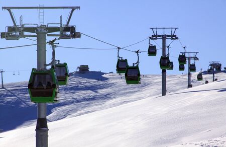Green cable cars in Transalpina ski resort, Romania, in winterの写真素材