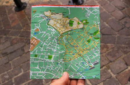 BERGAMO, ITALY - August 30, 2012: Illustrative editorial - Searching for directions on a city map with hand, in Bergamo, Italyのeditorial素材