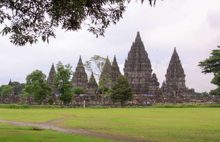 Famous Prambanan hindu temple, Yogyakarta, Java, Indonesia. Candi Prambanan seen from one side. Stone structures and rubble at iconic travel destinationのeditorial素材