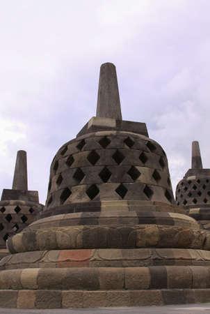 Stupas stone bell structures at Borobudur temple in Central Java, Indonesia. Candi Borobudur is the largest Buddhist temple in the world and one of the most important tourist attraction in Indonesiaのeditorial素材