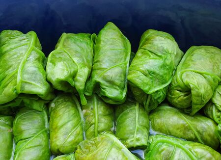 Green orache meat rolls packed together in pot before healthy cooking in the ovenの写真素材