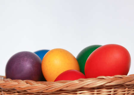 Colored painted Easter eggs in wooden basket decoration in preparation for holiday. Painting chicken or duck eggs is a Christian tradition to celebrate Easter all over the world.の写真素材