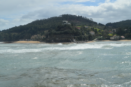 Mountain De Lequeito With Its Typical Basque Casonas Photo Taken From The Lonja Of Lekeitio. March 24, 2018. Islands Nature Landscapes. Lekeitio Vizcaya Basque Country Spain.の写真素材