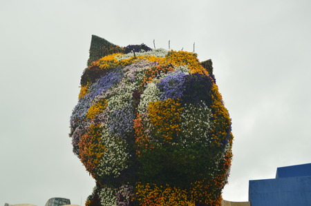 Sculpture Puppi Packed With Flowers And Colorful Is In The Entrance To The Guggenheim Museum Its Creator Was Jeff Coons. Art Travel Holidays. March 25, 2018. Bilbao Vizcaya Basque Country Spain.のeditorial素材