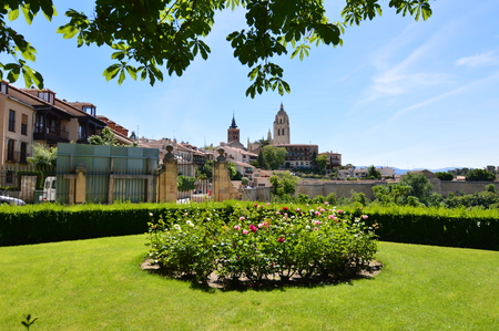 Nice Photo With The Bell Tower Of The Cathedral And The Old Quarter Behind A Rosebush In Segovia. Architecture, Travel, History. June 18, 2018. Segovia Castilla Leon Spain.のeditorial素材