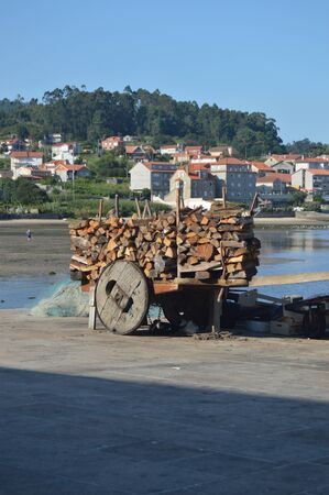 Cart Full Of Firewood Next To The Estuary Of The Beautiful Village Of Combarrro. Nature, Architecture, History, Street Photography. August 19, 2014. Combarro, Pontevedra, Galicia, Spain.のeditorial素材