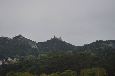 Wonderful Views Of The Palace Of Pena At The Top Of A Cliff On A Cloudy Day In Colares. Nature, architecture, history. April 14, 2014. Colares, Sintra, Lisbon, Portugal.のeditorial素材