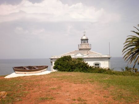Wonderful Lighthouse With A Boat At Its Doors In Candas. July 8, 2010. Asturias, Spain, Europe. Travel Tourism Street Photographyのeditorial素材