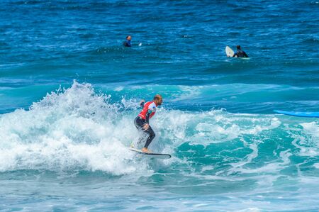 Redhead Man With Beard Breaking Waves On Las Americas Beach. April 11, 2019. Santa Cruz De Tenerife Spain Africa. Travel Tourism Street Photography.の写真素材