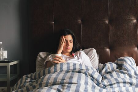 Young woman feeling sick with fever